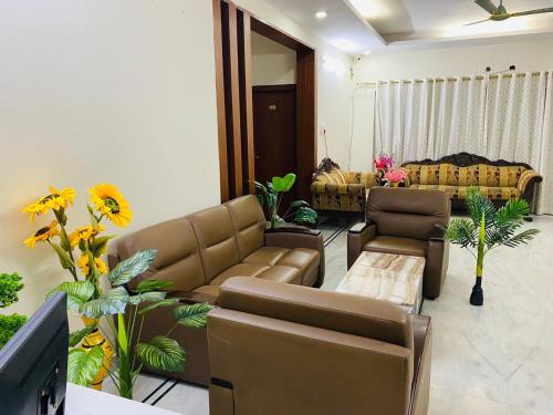 a living room with a couch and a television at KP Suites Gachibowli in Hyderabad