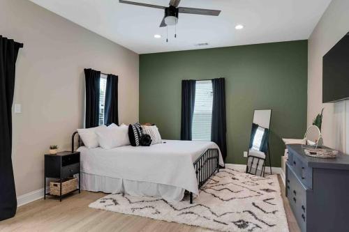 a bedroom with a bed and a ceiling fan at Memphis Midtown Oasis in the heart of Midtown! in Memphis