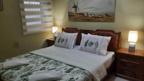 una camera con letto con cuscini e mulino a vento di Lalovina Apartment a Herceg-Novi