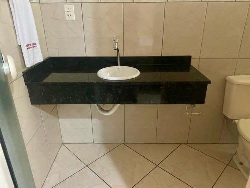 a bathroom with a sink and a toilet at Hotel Jovilá in Jaraguá do Sul