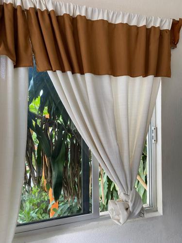 a window with a curtain in a room at Hotel Villa del Mar in Tonalá