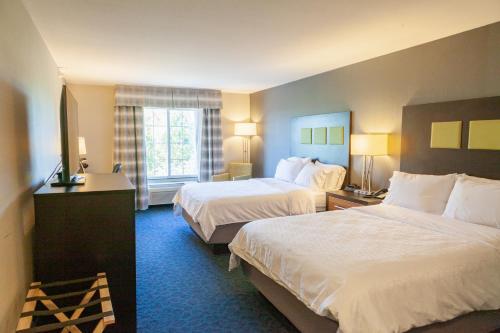 a hotel room with two beds and a window at Holiday Inn Express Jackson by IHG in Jackson