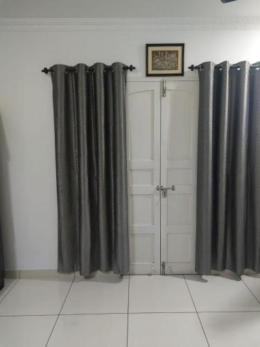 a room with black curtains and white doors at annies inn homestay in Cochin