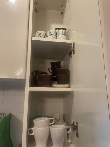 a cupboard with cups and dishes on it at Albero Mago in Florence