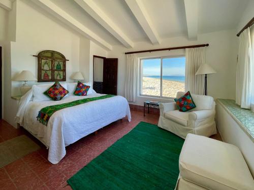 a bedroom with a bed and a couch and a window at Rancho Las Cruces in Las Cruces