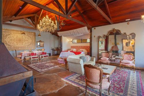 a living room filled with furniture and a chandelier at Pousada Loft da Serra in Lavras Novas