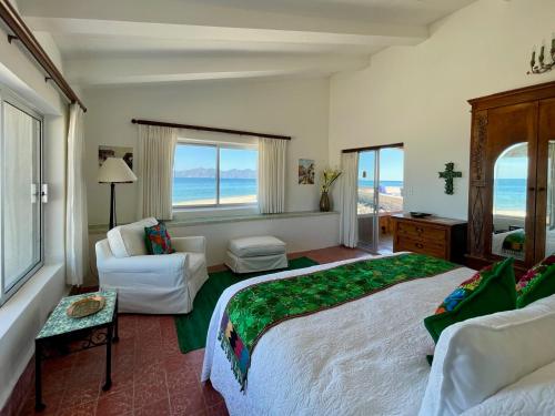 a bedroom with a large bed and a living room at Rancho Las Cruces in Las Cruces