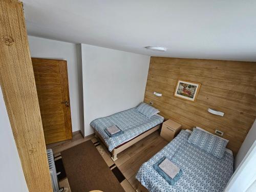 a small room with two beds and a door at Ruža vetrova in Kušići