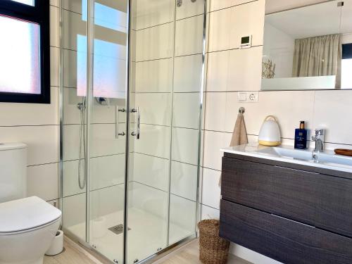 a bathroom with a shower and a toilet and a sink at Casa Onesta Luxery apartment with private rooftop terrace in Orihuela