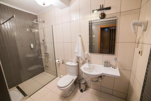 uma casa de banho com um chuveiro, um WC e um lavatório. em Etno selo Stanišići Hotel Ras em Dijelovi