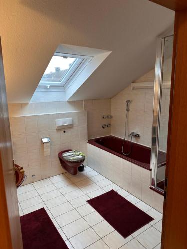 a bathroom with a tub and a toilet and a shower at Entspannungsoase Haus Iris in Kirchham