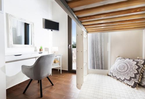 a room with a chair and a desk and a television at Villa Elisabeth View in Plataniás