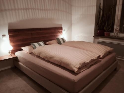 un grande letto in una camera da letto con luce accesa di Old Town Apartment, Free Parking a Liptovský Mikuláš