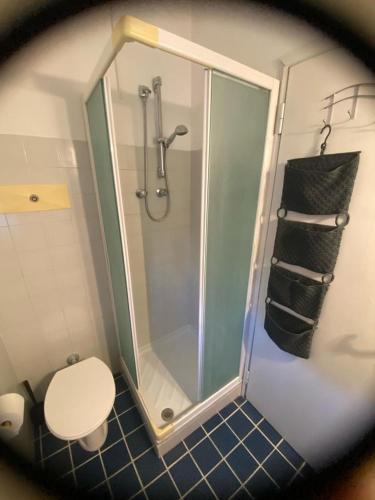 a bathroom with a shower with a toilet and a glass shower stall at Casa di Anna in Ravenna