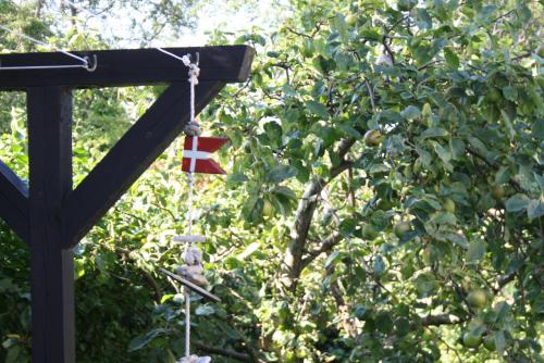 a flag on a pole next to a tree at Holiday-Skagen in Skagen