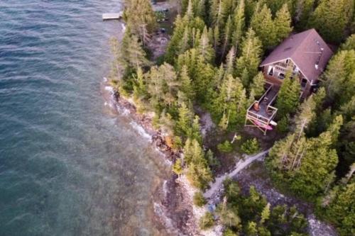 an aerial view of a house on an island in the water at Blue Vista Tobermory Waterfront Cottage in Tobermory