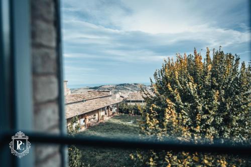 a window with a view of a tree and a building at Palazzo Capparucci - Dimora storica in Fermo