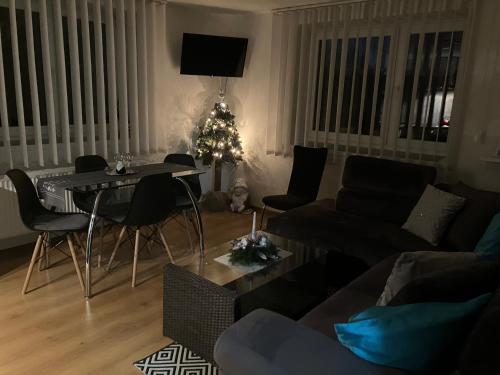 a living room with a table and a christmas tree at Apartmán Karin in Huty