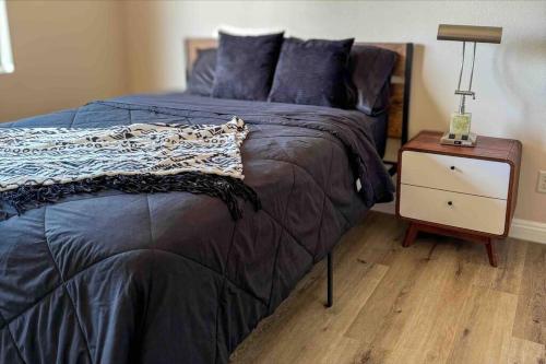 a bedroom with a bed and a night stand at San Diego Trail Guest Ranch in Poway
