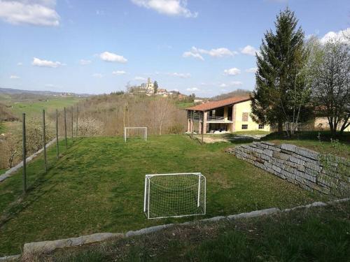 a soccer field with a goal in the grass at casa nel verde Cà dla cola in Mombasiglio