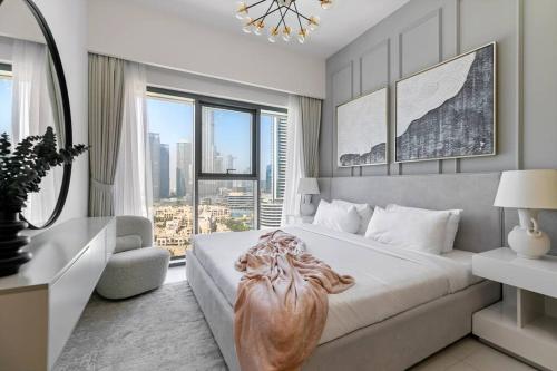 - une chambre avec un grand lit et une grande fenêtre dans l'établissement Keysplease Beautiful 2BR Burj Khalifa View, Burj Royale Downtown, à Dubaï