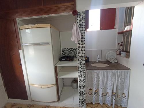 uma pequena cozinha com um lavatório e um frigorífico em Refugio Piratininga 201 em Niterói