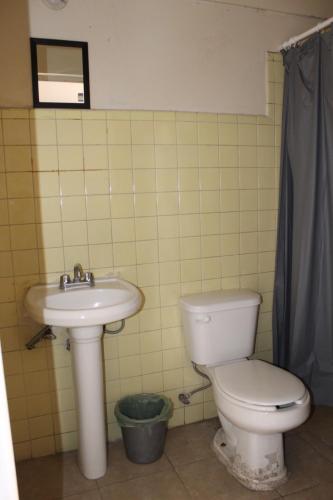 a bathroom with a toilet and a sink at Hotel El Rincón de Jesusita in Durango