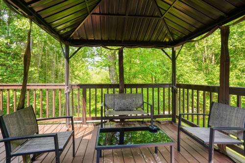 a gazebo with chairs and a table on a deck at Hideaway Pines in Logan