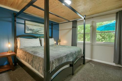 a bedroom with a canopy bed and a window at Hideaway Pines in Logan