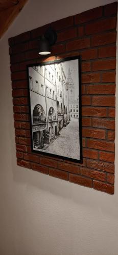 a picture of a brick wall with a picture on it at Apartament z duszą in Kłodzko