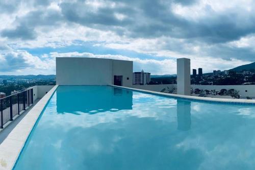 a swimming pool on the roof of a building at Entire Beautiful condo with rooftop pool and gym in Colonia San Benito
