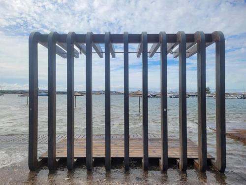 a metal fence in front of a body of water at CerezinoFlats-Estúdio Vista Baía in Seixal