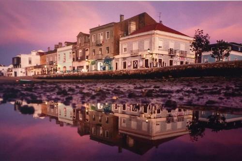 a large building sitting next to a body of water at CerezinoFlats-Orange Bay Studio in Seixal