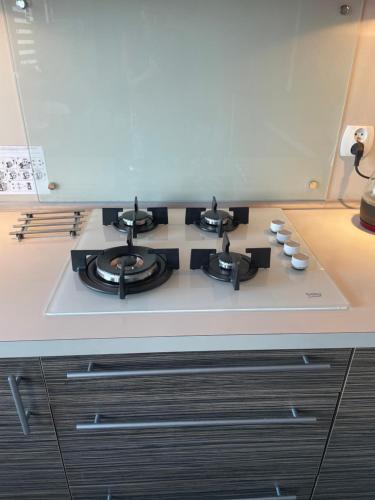 a stove top oven sitting on top of a kitchen counter at AS Apartment Lodz in Łódź