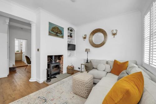 a white living room with a couch and a fireplace at Charming Church Walk, Long Melford - 2 bedroom property with parking in Long Melford