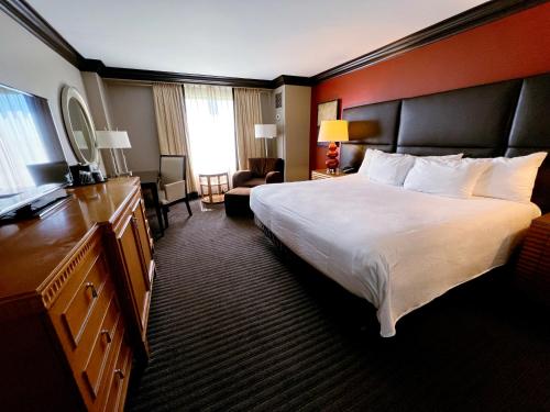 a hotel room with a large bed and a desk at Ameristar Casino Hotel Vicksburg, Ms. in Vicksburg
