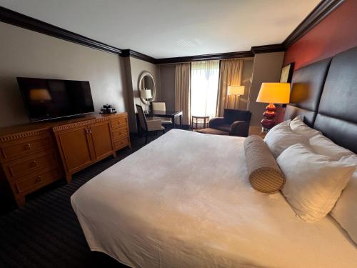 a hotel room with a large bed and a television at Ameristar Casino Hotel Vicksburg, Ms. in Vicksburg