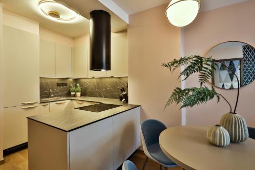 a kitchen with a table and a dining room at Sun Hill Luxury Suites in Budapest