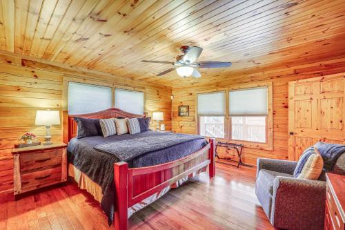 a bedroom with a bed and a ceiling fan at Waterfront Watauga Lake Home with Private Dock! in Butler