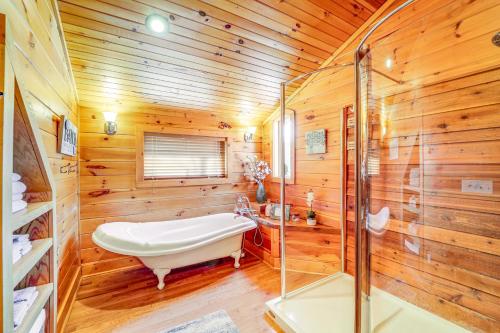 een houten badkamer met een bad en een douche bij Waterfront Watauga Lake Home with Private Dock! in Butler
