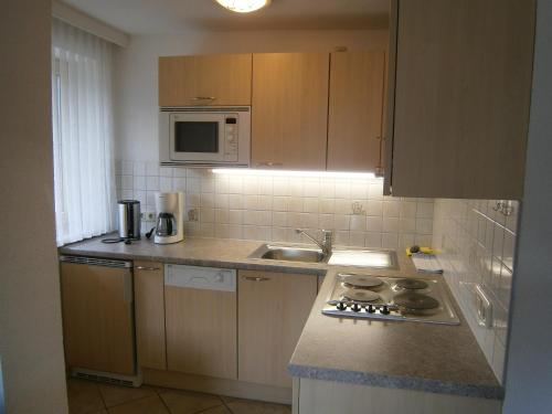 a kitchen with a sink and a stove top oven at Alpenview Lechtal in Holzgau