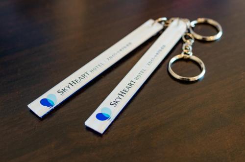 two pair of keychains sitting on top of a table at Sky Heart Hotel Koiwa - Vacation STAY 51656v in Tokyo