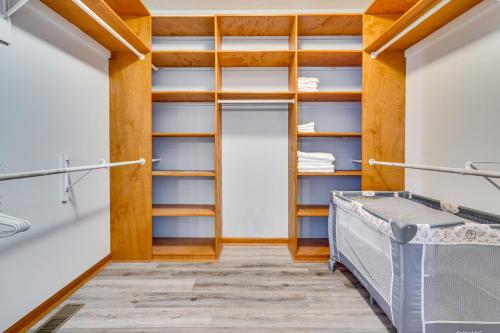 a walk in closet with wooden shelving at Elegant Pataskala Home with Hot Tub and Fire Pit! in Pataskala