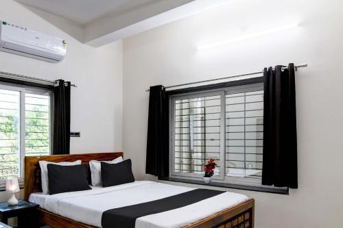 a bedroom with a large bed and a window at OYO Flagship SS INN Hotels & Homes in Khandagiri