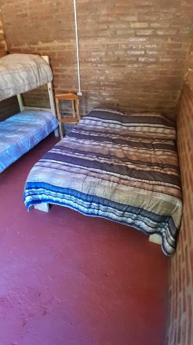 a bedroom with two beds in a wooden room at Patriada Ranch in El Hoyo