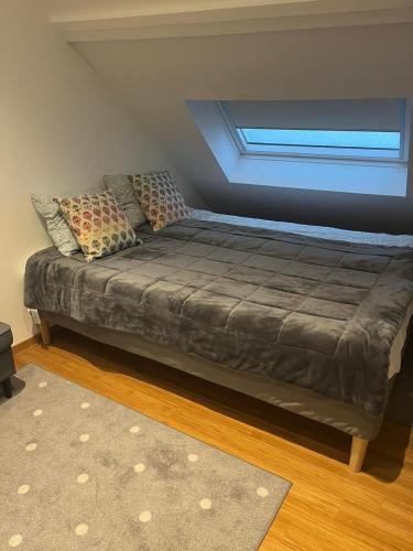 a bed in a room with a window at Au Marolles chambre Atomium in Brussels