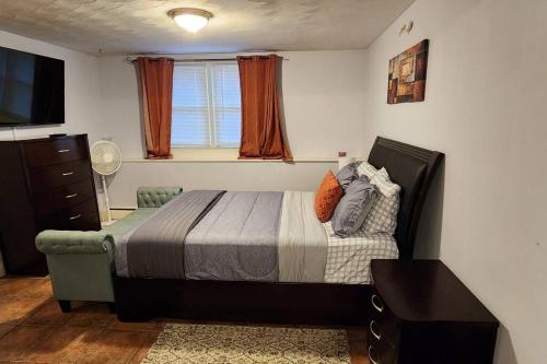 a bedroom with a bed and a window at Beautiful & Cozy one Bedroom Apartment near Boston & Airport in Saugus