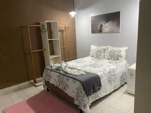 CONFORT HOTEL ARAPIRACA في أرابيراكا: غرفة نوم بسرير وسجادة وردية