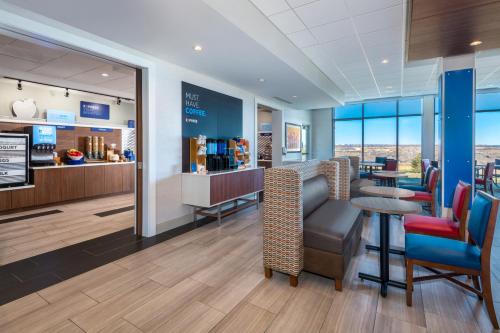 a waiting room with chairs and a table and a counter at Holiday Inn Express & Suites - Colorado Springs South I-25 by IHG in Colorado Springs