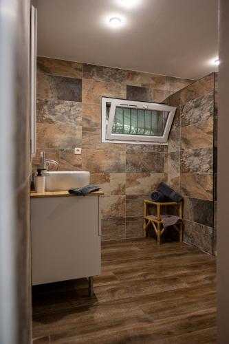 a bathroom with a sink and a window at leverest rooms in Marseille